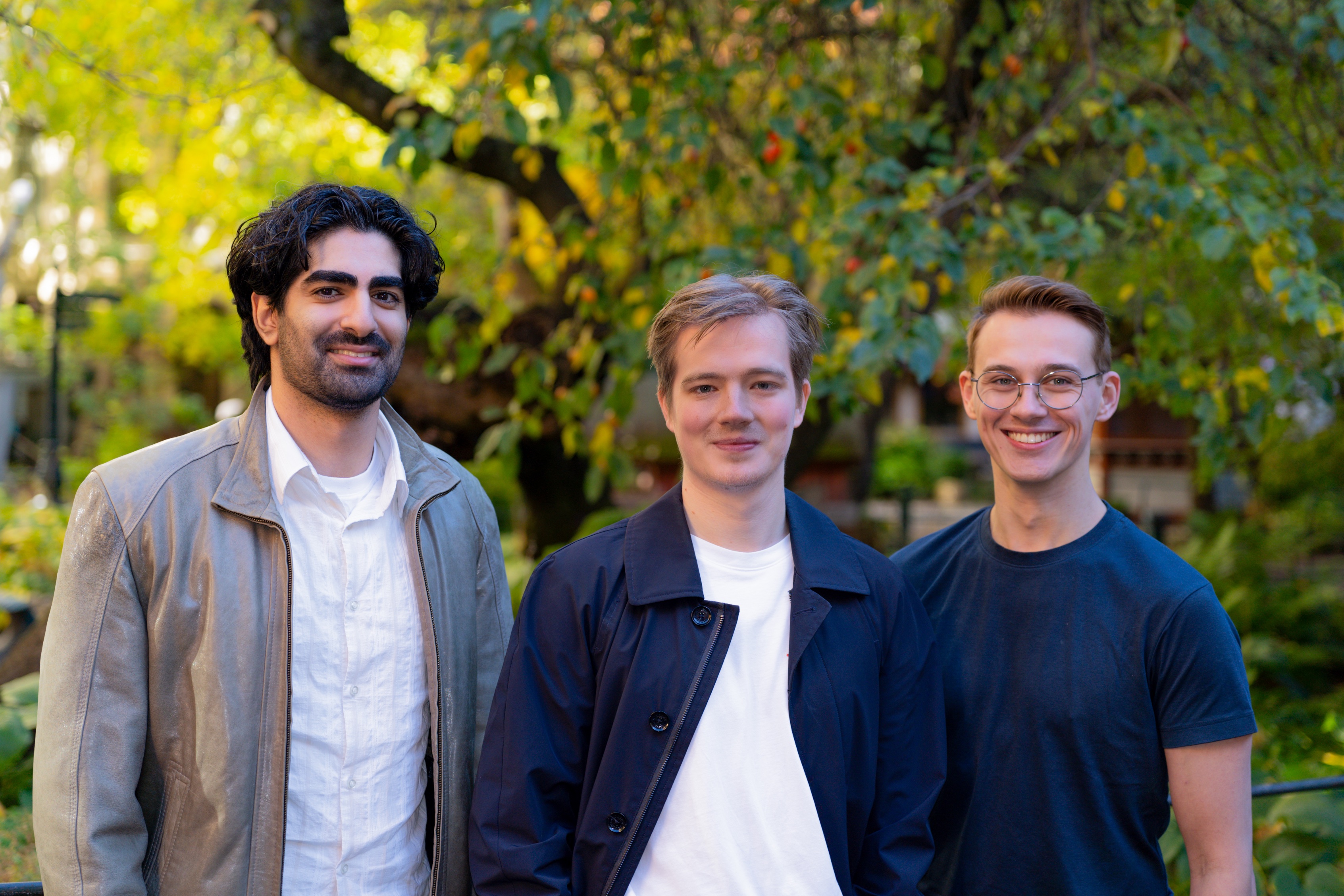 Strawberry's founders Arian Hanifi, Charles Maddock, and Sebastian Thunman standing together under autumn trees.